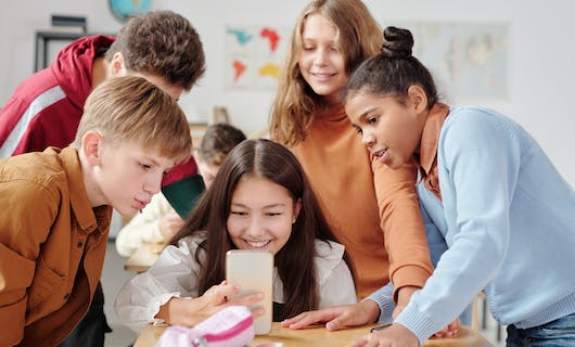 Kinder schauen auf ein Smartphone